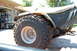 1985 Ford Ranger - A three-wheeled ATV is parked outdoors, showing its rear tire and part of its body.