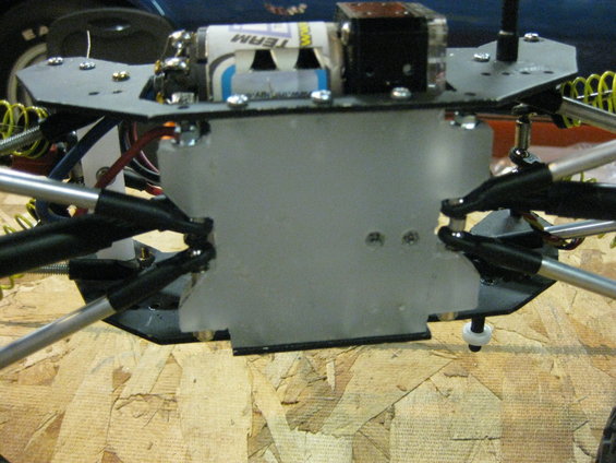 RC car chassis with batteries and suspension components