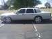 1992 Lincoln Town Car - A silver sedan with tinted windows and chrome wheels is shown from the side.