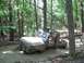 1987 Suzuki Samurai - A Suzuki Samurai navigates a muddy trail through a dense forest.