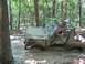1987 Suzuki Samurai - This 1987 Suzuki Samurai is stuck deep in the mud while off-roading through a wooded area.