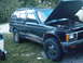 1994 GMC Jimmy - This 1994 GMC Jimmy SUV is parked outdoors with its hood open, revealing the engine compartment.