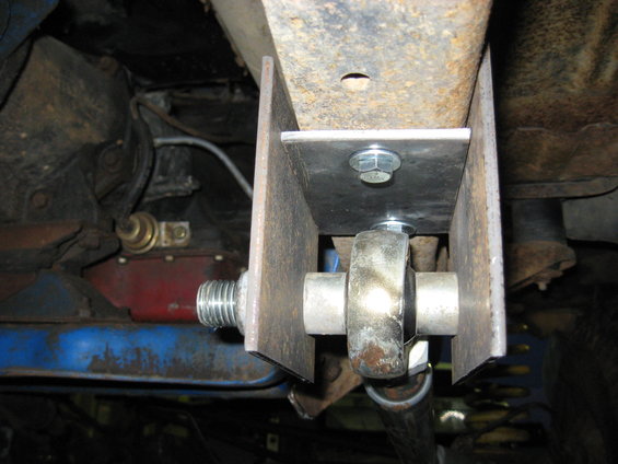 Close-up of a custom suspension bracket with a spherical bearing and threaded rod