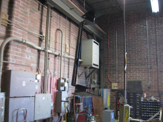 Industrial interior with brick walls, pipes, electrical boxes, and machinery