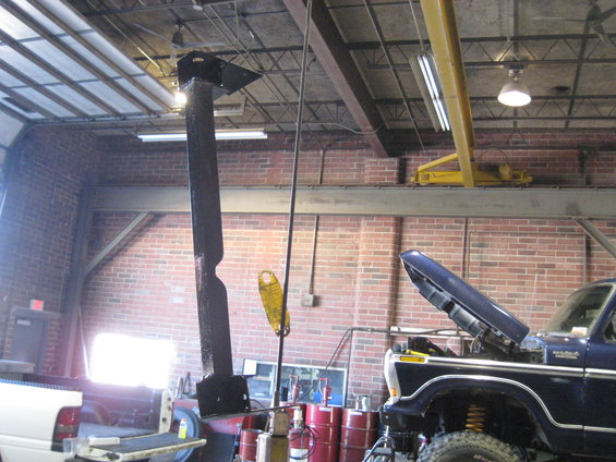 1978 Ford Bronco with hood open, parked in a garage next to a white pickup truck