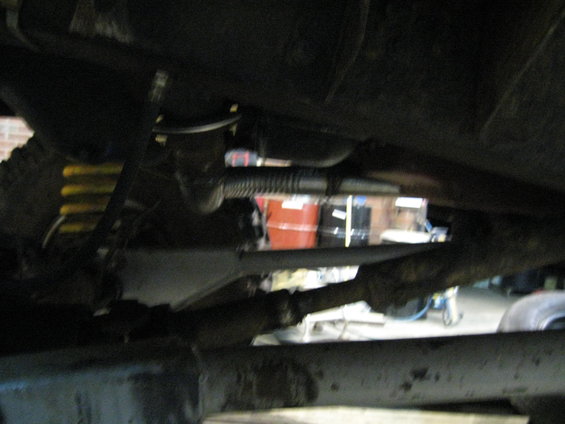 Undercarriage view showing suspension components and exhaust system