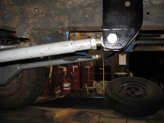 Close-up of vehicle suspension linkage and frame components