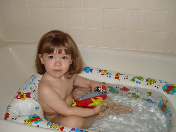 mias-2nd-birthday-028.jpg After opening her first present (a little einstein's bath toy), she insisted on taking a bath with it - immediately!!