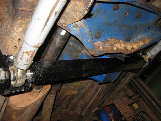Undercarriage view showing suspension parts, exhaust, and blue painted frame components