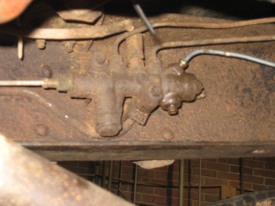 Rusty brake proportioning valve assembly mounted on a vehicle frame