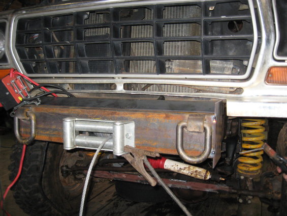 Custom front bumper with winch and D-rings on a vehicle