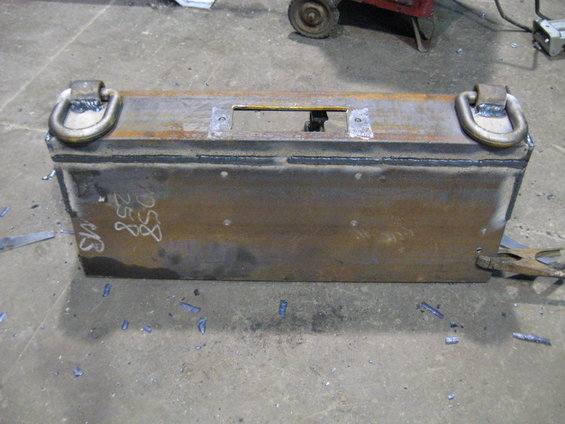 Metal box with D-rings on top, welded construction, marked with numbers