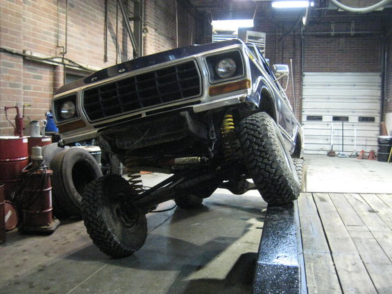 Front view of a 1978 Ford Bronco on a lift in a garage