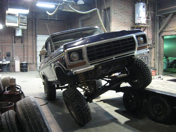Dark blue 1978 Ford Bronco with lifted suspension on a trailer