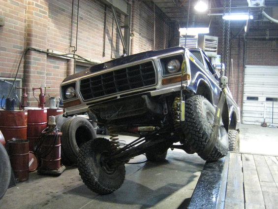 1978 Ford Bronco on a lift, front view, showing modified suspension and large tires