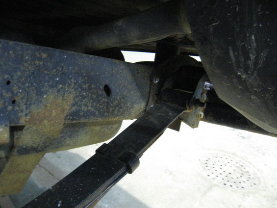 Close-up of a vehicle's leaf spring and frame