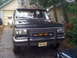 1988 Ford Bronco - Front view of a black Ford Bronco with aftermarket modifications.