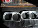 1975 Ford Ranchero - Two headlight bezels are shown in the bed of a pickup truck, with a taillight visible at the top.