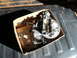 1975 Ford Ranchero - A carburetor and its accompanying gasket are presented in a cardboard box, likely for sale or storage.
