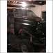 1994 Ford F-250 - This 1994 Ford F-250 is undergoing repairs, with its front fender and hood removed to access the engine and interior.