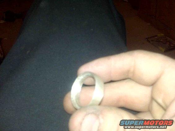Metal ring held in hand, with Supermotors.net watermark