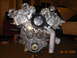 1995 Ford Taurus - Close-up view of a V8 engine, with a white car visible in the background.