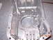 1995 Ford Taurus - Close-up of an aluminum oil pan, likely for an engine rebuild or repair.