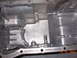 1995 Ford Taurus - This is a close-up view of an oil pan, likely from an engine, showing its internal structure and mounting points.