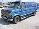 1978 Ford E150 - This blue 1978 Ford E150 van is shown from a 3/4 front angle, custom wheels and a hood protector.