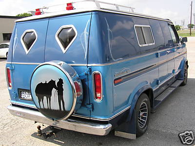 1978 Ford E150 van, blue with custom paint and spare tire cover showing a cowboy and horse