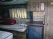 1978 Ford E150 - Interior view of a camper van showing the living area with seating and storage.