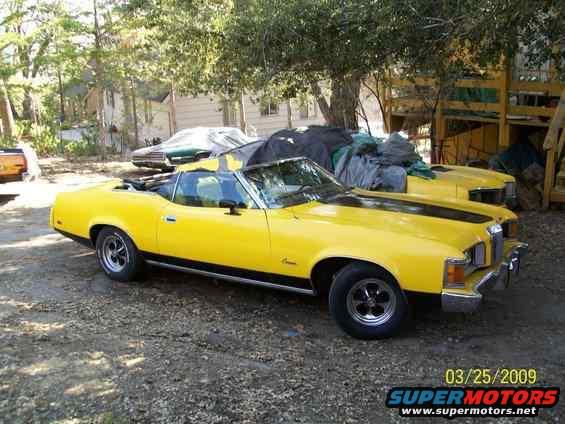1973 Mercury Cougar convertible parked outside with another yellow car behind it