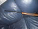 1991 Ford Bronco - A rifle with a wooden stock is placed on a blue leather couch.