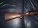 1991 Ford Bronco - A close-up view of the wooden stock and bolt mechanism of a rifle.