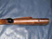 1991 Ford Bronco - A close-up view of a wooden gun stock, showing its smooth finish and hardware details.