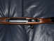 1991 Ford Bronco - The action and wooden stock of a rifle are shown in detail against a dark background.