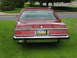 1984 Mercury Grand Marquis - The rear of a maroon 1984 Mercury Grand Marquis LS is parked on a grassy lawn next to a road.