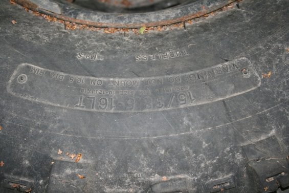 Tire sidewall showing 15/38-16LT size and "TUBELESS" text