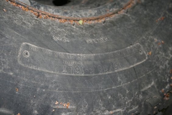 Close-up of tire sidewall showing size 15/38-16LT and mount on 16.5 dia rim