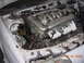 1995 Ford Taurus - The engine bay of a white vehicle is shown, a V6 engine with prominent intake runners.