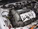 1995 Ford Taurus - Close-up view of a vehicle's engine bay, white valve covers and various engine components.