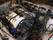 1995 Ford Taurus - The engine bay is shown with a hoist and chains, indicating repair work is in progress.