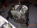 1995 Ford Taurus - Engine removed from a vehicle, suspended by chains in a workshop setting.