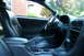 2002 Ford Mustang - The interior of a 2002 Ford Mustang, black leather seats and the driver's side controls.