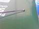 1985 Ford Ranger - A close-up view of a thin metal rod with a ball end, positioned on a green surface that has some visible text.