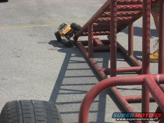 Yellow remote control rock crawler toy on a red metal ramp