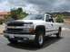 1979 Chevrolet C/K Pickup - This white Chevrolet pickup truck is shown from a three-quarter front angle under a cloudy sky.
