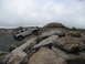 1991 Ford Bronco - A silver Hummer H3 navigates a challenging rocky obstacle course under an overcast sky.
