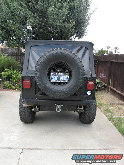 Black Jeep CJ with spare tire on back, custom bumper, and license plate reading BAJA JEP