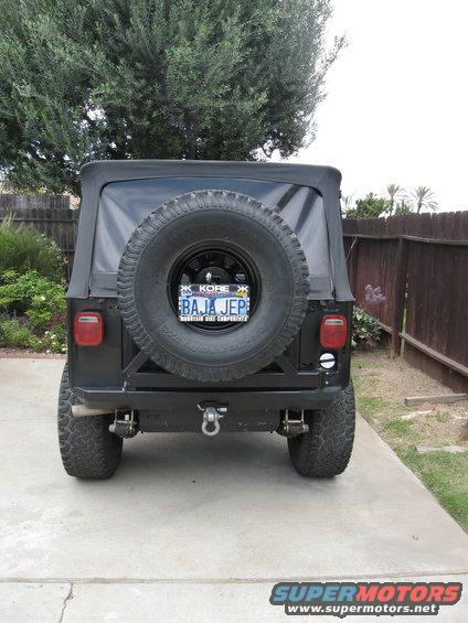 Black Jeep CJ with spare tire on rear, custom bumper, and Baja Jeep license plate